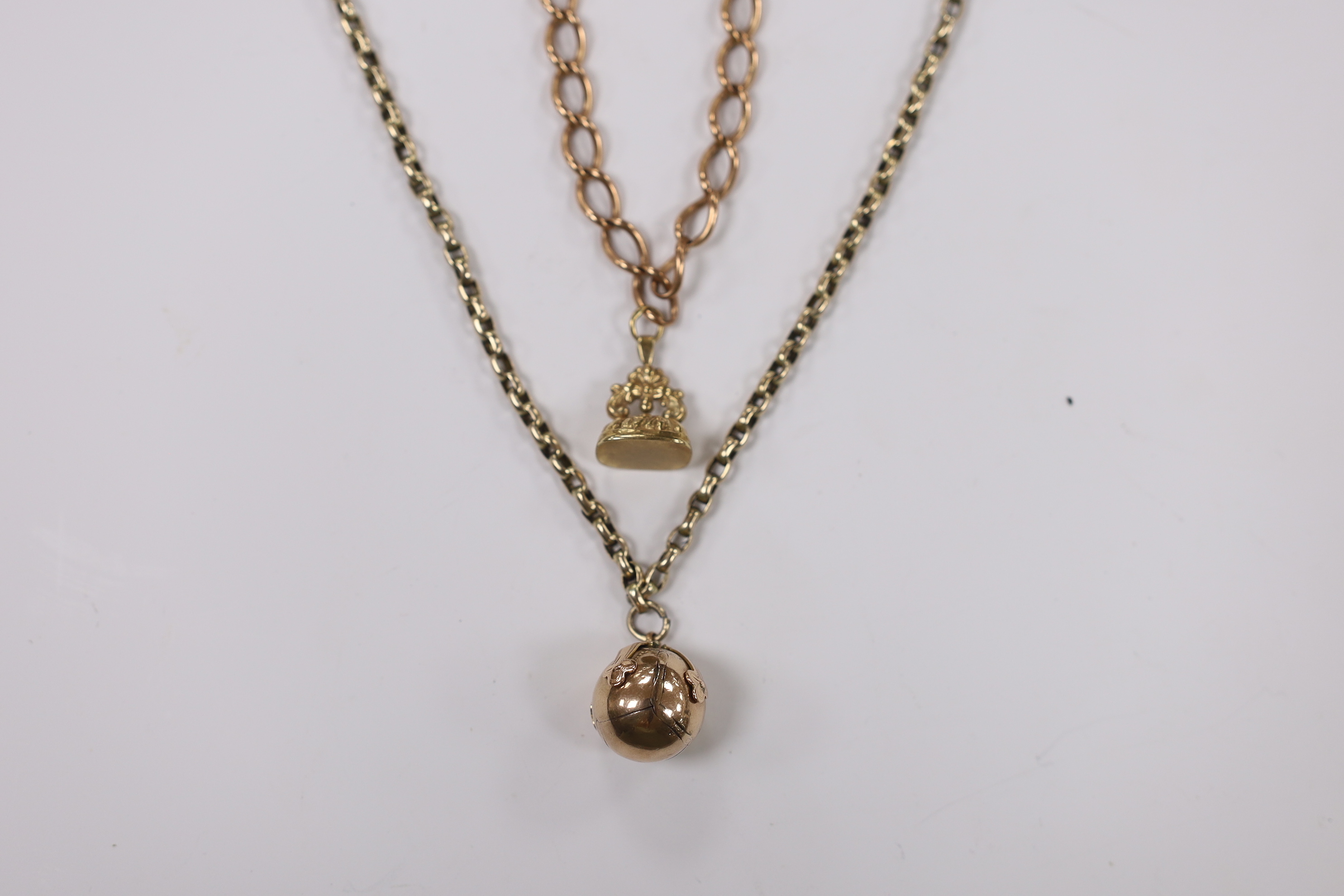 A yellow metal overlaid fob seal on a damaged 9ct gold bracelet, together with a yellow metal masonic ball on a yellow metal chain.